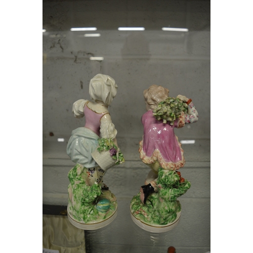 607 - A pair of 19th century porcelain figures of a young boy and girl.