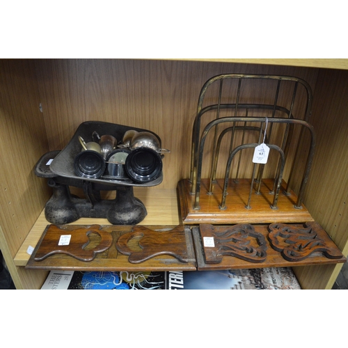 63 - A brass and oak magazine rack, two book rests, kitchen scales and trophy cups.