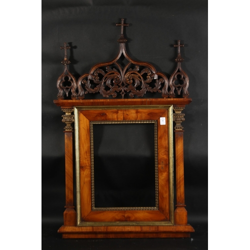 31 - A 19th Century Italian walnut tabernacle frame with carved scrolling top ornament, rebate size 15