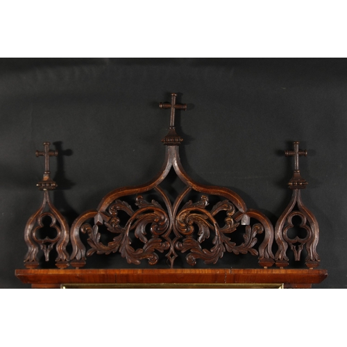 31 - A 19th Century Italian walnut tabernacle frame with carved scrolling top ornament, rebate size 15