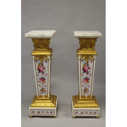 509 - A GOOD PAIR OF PORCELAIN AND ORMOLU MARBLE TOP PEDESTALS, painted with flowers. 4ft 2ins high , the ... 