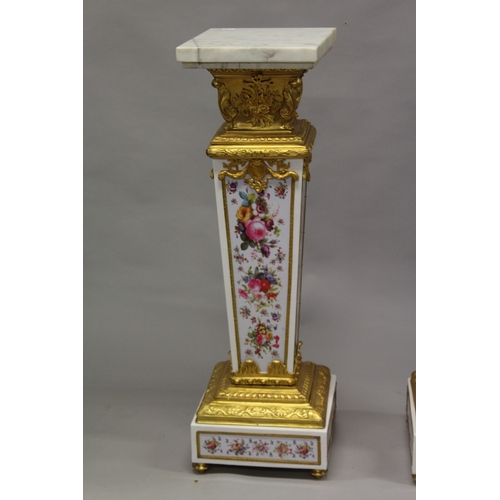 509 - A GOOD PAIR OF PORCELAIN AND ORMOLU MARBLE TOP PEDESTALS, painted with flowers. 4ft 2ins high , the ... 