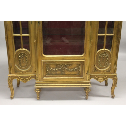 520 - A LARGE GILTWOOD BREAKFRONT STANDING CUPBOARD with large central glass panel door, doors to the side... 