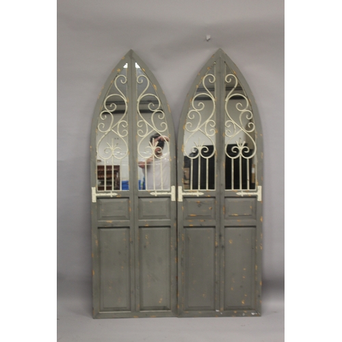 523 - A PAIR OF ARCH TOP MIRRORED PANELS. 5ft 9ins high x 1ft 10ins wide.