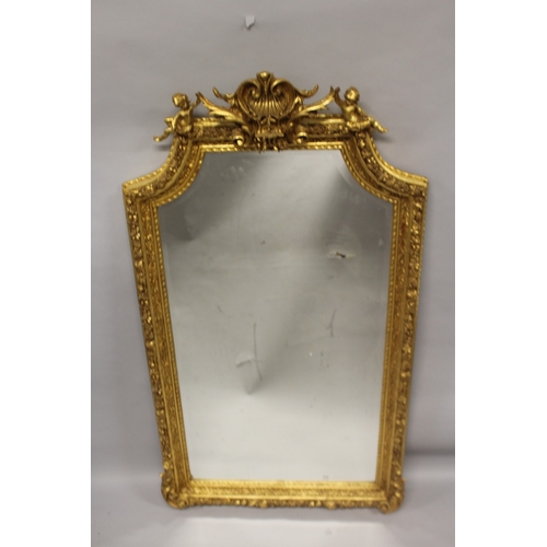 525 - A GOOD LOUIS XVITH STYLE GILTWOOD GILDED UPRIGHT MIRROR with acanthus, shells and cupids. 5ft 9ins h... 