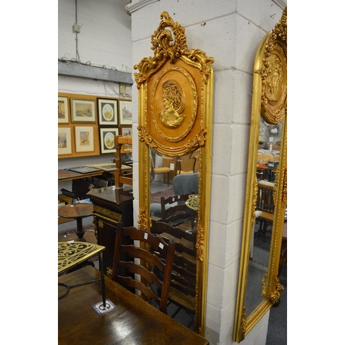 530 - A GOOD PAIR OF GILTWOOD LONG NARROW MIRRORS with a large circular portrait. 6ft high x 1ft 6ins wide... 