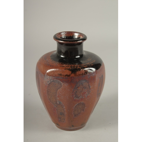 563 - A STUDIO POTTERY TAPERING HEXAGONAL SHAPE VASE, in the manner of Bernard Leach. 15cms high.