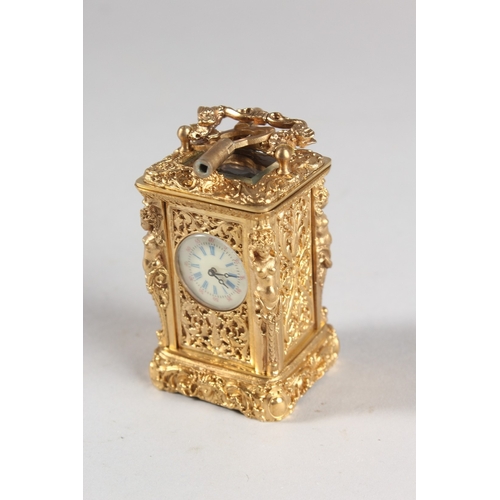 875 - A GOOD MINIATURE CAST METAL CARRIAGE CLOCK, the sides with female figures. 2.5ins high.