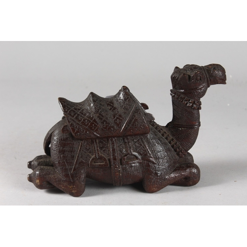 106 - A FINELY CARVED 19TH CENTURY INDIAN WOODEN CAMEL, 20cm long.