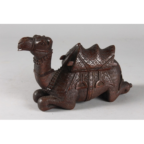 106 - A FINELY CARVED 19TH CENTURY INDIAN WOODEN CAMEL, 20cm long.