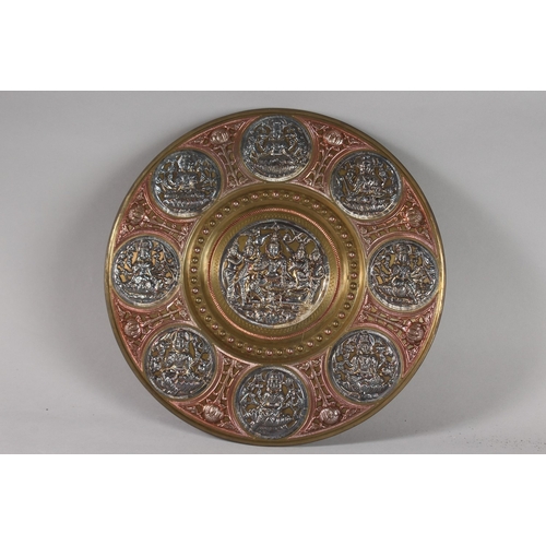 116 - A SOUTH INDIAN TANJORE SILVER AND COPPER OVERLAID BRASS CHARGER, with Hindu deities, 31cm diameter.