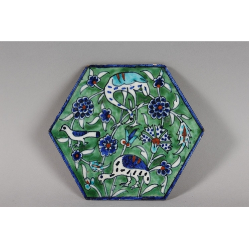 120 - AN EARLY 20TH CENTURY PALISTIAN ARMENIAN HEXAGOAL POTTERY TILE, depicting birds and folate motifs, 1... 