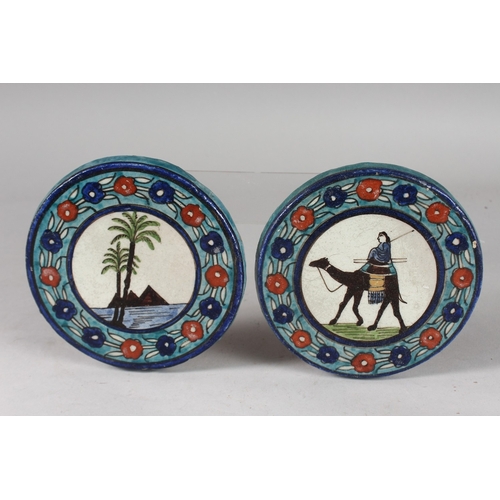 121 - TWO UNUSUAL EARLY 20TH CENTURY PALISTIAN ARMENIAN CIRCULAR POTTERY TILES, 14cm diameter.