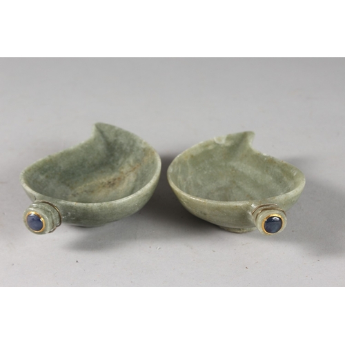 128 - A PAIR OF EARLY 20TH CENTURY INDIAN CARVED GREEN STONE PAISLEY SHAPE BOWLS, inset with blue gemstone... 