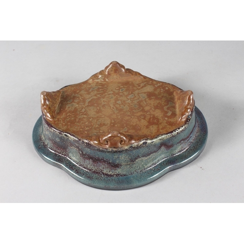 14 - A CHINESE FLAMBE GLAZED POTTERY QUATREFOIL FORM BOWL, raised on four feet, 24cm x 18.5cm.