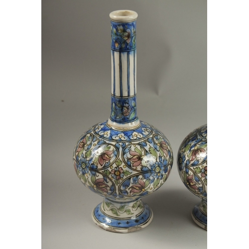 153 - A FINE PAIR OF 19TH CENTURY PERSIAN QAJAR GLAZED POTTERY BOTTLE VASES, 32cm high.