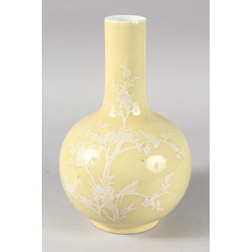 16 - A CHINESE YELLOW GLAZE PORCELAIN BOTTLE VASE, decorated with white enamelled tree and birds, the bas... 