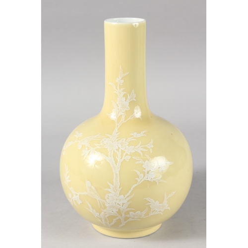 16 - A CHINESE YELLOW GLAZE PORCELAIN BOTTLE VASE, decorated with white enamelled tree and birds, the bas... 