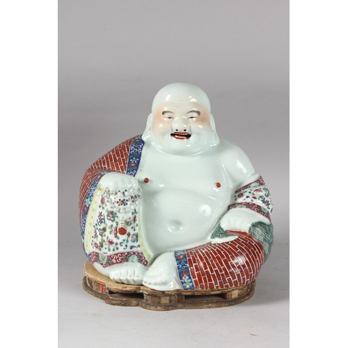 161 - A LARGE CHINESE PORCELAIN LAUGHING BUDDHA, on a shaped stand, the robes painted with flowers and bri... 