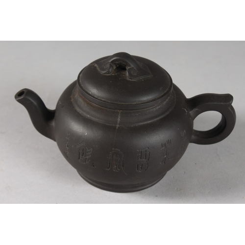 166 - A CHINESE BLACK YIXING TEAPOT, with impressed mark to base.