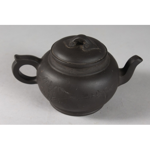 166 - A CHINESE BLACK YIXING TEAPOT, with impressed mark to base.