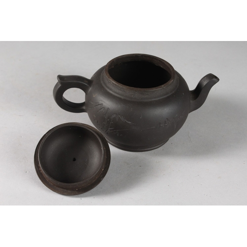 166 - A CHINESE BLACK YIXING TEAPOT, with impressed mark to base.