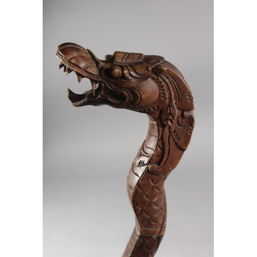 167 - A CARVED DRAGON FORM WOODEN CANE, 98cm long.