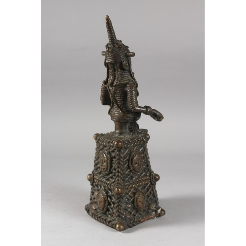 168 - A BENIN FIGURAL BRONZE BELL, 38cm high.