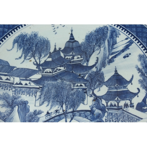 172 - A LARGE 19TH CENTURY CHINESE BLUE AND WHITE PORCELAIN CHARGER, painted with a landscape scene illust... 