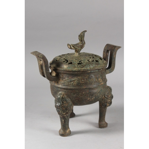 176 - A CHINESE ARCHAIC STYLE BRONZE TWIN HANDLE TRIPOD CENSER, 28cm high.