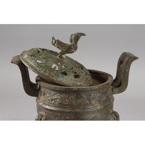 176 - A CHINESE ARCHAIC STYLE BRONZE TWIN HANDLE TRIPOD CENSER, 28cm high.