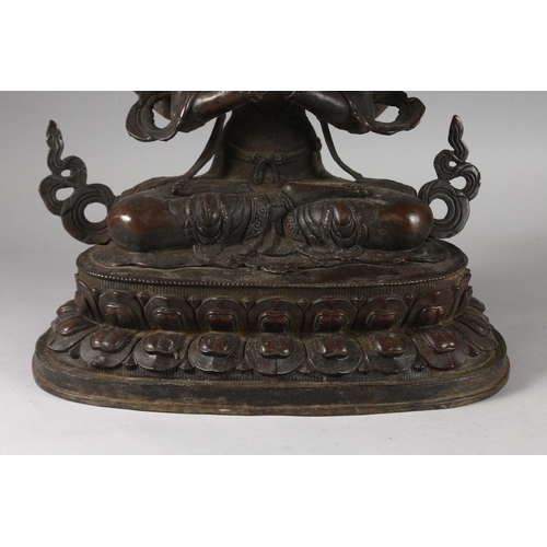 179 - A VERY LARGE BRONZE SEATED DEITY ON A LOTUS BASE, 48cm high.