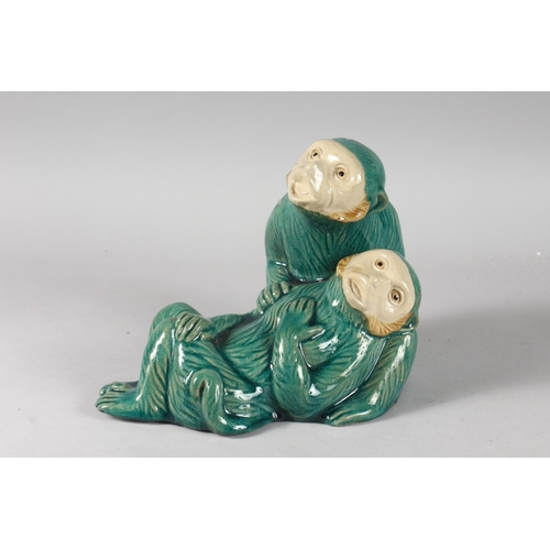 18 - A LARGE CHINESE TURQUOISE GLAZED POTTERY GROUP OF TWO MONKEYS, the base with impressed mark, 27cm lo... 