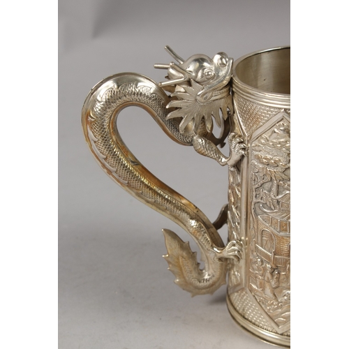 182 - A VERY FINE CHINESE SILVER TANKARD, with cast dragon form handle, finely engraved with relief panels... 