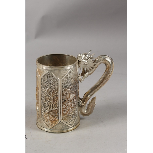 182 - A VERY FINE CHINESE SILVER TANKARD, with cast dragon form handle, finely engraved with relief panels... 