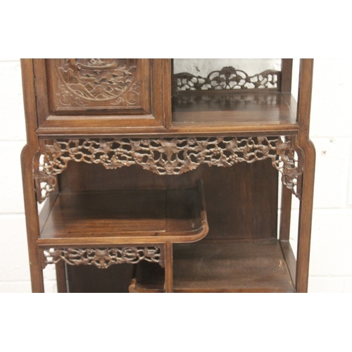 185 - A LATE 19TH CENTURY CARVED HARDWOOD DISPLAY CABINET with two decoratively carved panel doors, a call... 