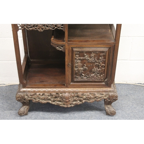 185 - A LATE 19TH CENTURY CARVED HARDWOOD DISPLAY CABINET with two decoratively carved panel doors, a call... 