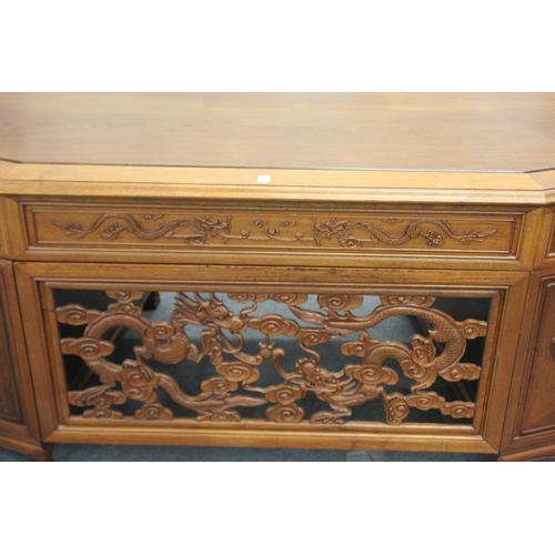 186 - A LARGE CHINESE WOODEN DESK, with openwork front panel and seven drawers, 210cm wide, 77cm high, 96c... 