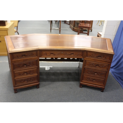 186 - A LARGE CHINESE WOODEN DESK, with openwork front panel and seven drawers, 210cm wide, 77cm high, 96c... 