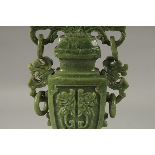 203 - A LARGE CHINESE CARVED GREEN HARDSTONE LIDDED VASE, with twin drop ring handles and carved with dog ... 