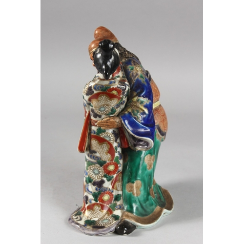 217 - A 19TH CENTURY JAPANESE KUTANI PORCELAIN FIGURAL GROUP, 25.5cm high.