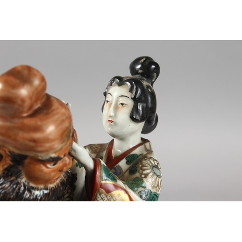 217 - A 19TH CENTURY JAPANESE KUTANI PORCELAIN FIGURAL GROUP, 25.5cm high.