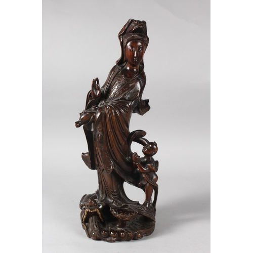 22 - A 19TH CENTURY CHINESE CARVED ROOTWOOD GUANYIN FIGURE, stood upon a dragon-like beast with inset eye... 