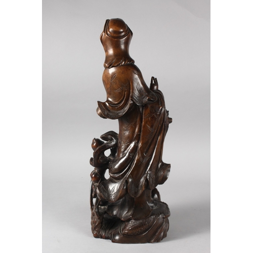 22 - A 19TH CENTURY CHINESE CARVED ROOTWOOD GUANYIN FIGURE, stood upon a dragon-like beast with inset eye... 