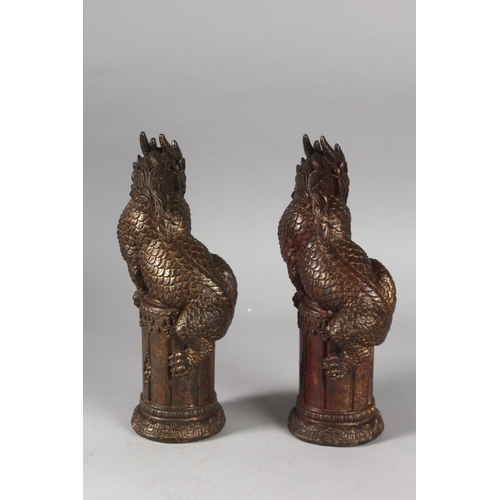 223 - A PAIR OF CHINESE GILDED BRONZE DRAGONS, 25.5cm high.