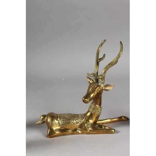 225 - A PAIR OF BRASS DEER, together with three brass immortals with wooden stands, (5).