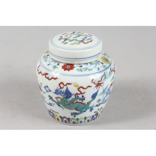 239 - A CHINESE DOUCAI PORCELAIN POT AND COVER, 10cm high.