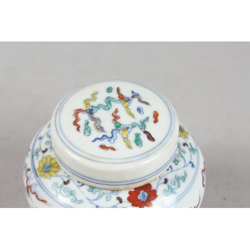 239 - A CHINESE DOUCAI PORCELAIN POT AND COVER, 10cm high.