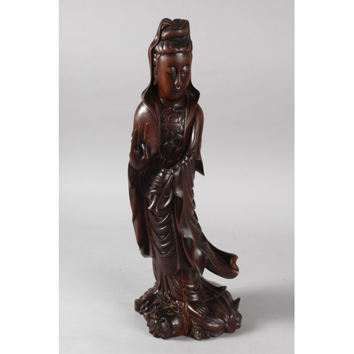 24 - A CHINESE CARVED HARDWOOD FIGURE OF GUANYIN, 40cm high.