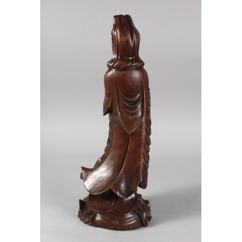 24 - A CHINESE CARVED HARDWOOD FIGURE OF GUANYIN, 40cm high.